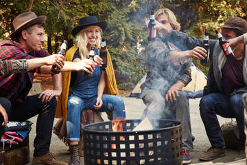 Group of friends camping around doing a toast