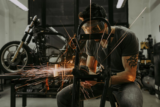 Male polishing motorbike frame