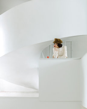 Woman with apple in white modern interior