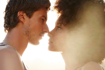 Mixed race couple in love looking at each other