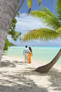 Couple walking on beach on vacation