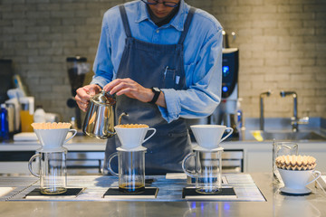 Barista making drip coffee in coffee shop