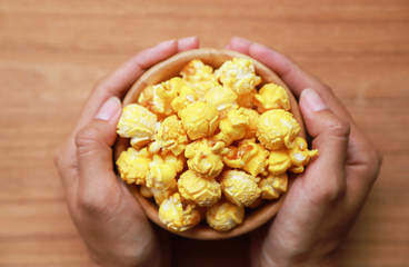 baked popcorn for eating in wooden bowl 