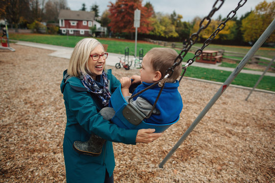 Happy grandma playing with grandkid outside