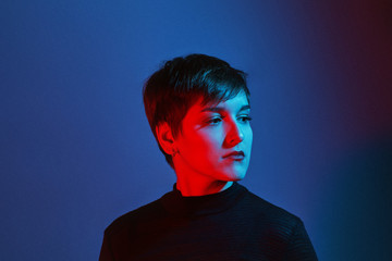 Portrait of young woman in blue and red light