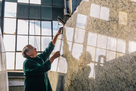 Senior Worker Measuring Stone Slab