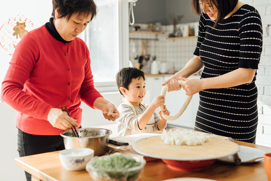 Muti-generation family cooking in kitchen