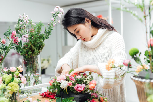 Young asian girls making flower arrangement