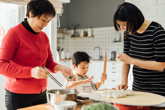 Muti-generation family cooking in kitchen