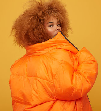 Young woman studio portrait giving back