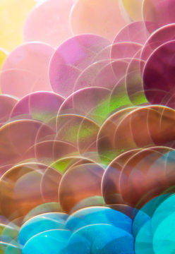 Mermaid scale paillettes photographed through a prism
