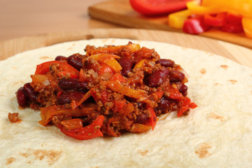 Making Burrito. Tortilla with meat, beans and bell pepper. Series. 