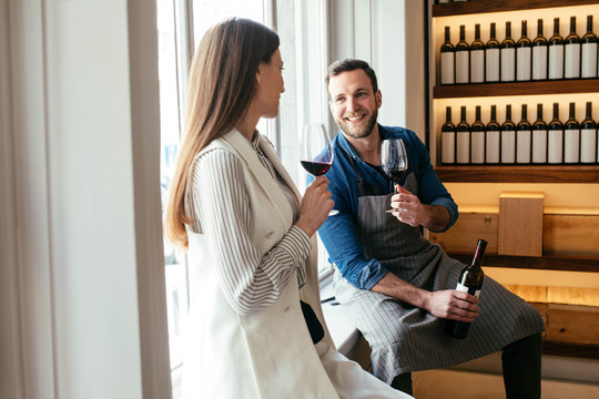 A Man and a Woman Drinking Wine at Wine Bar
