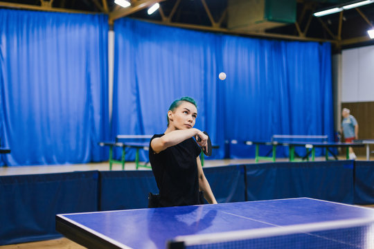 Woman in wheelchair playing table tennis