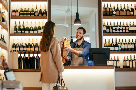 A Woman Buying a Wine at Winery