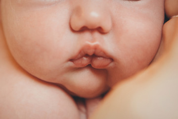 portrait of newborn baby. nose and lips close up. Concept of healthcare: diseases of the ENT, lips, mouth