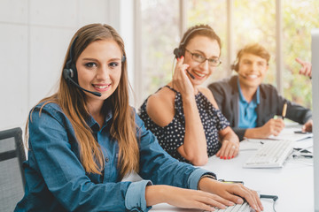 Service phone operators use headset and computer, focus on people answers incoming telephone calls directing to appropriate department, takes messages from clients, assistance distantly concept.