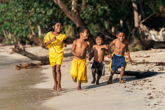 Asian kids running on seashore