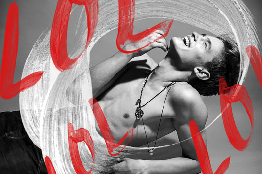 Portrait of a young handsome smiling guy in the studio