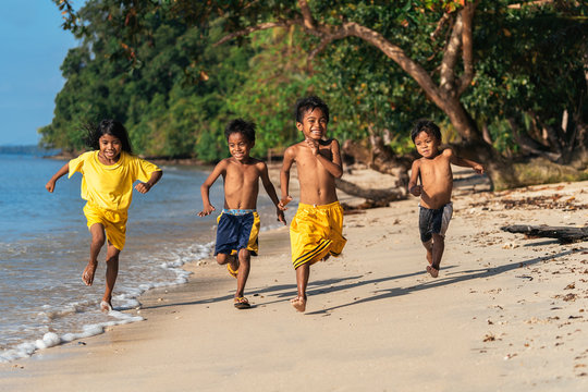 Asian kids running on seashore