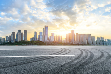 Empty asphalt road and Chongqing cityscape at sunset
