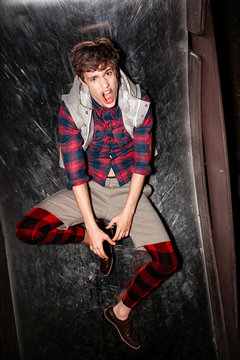 Fashionable portrait of a young guy in stylish clothes in the night
