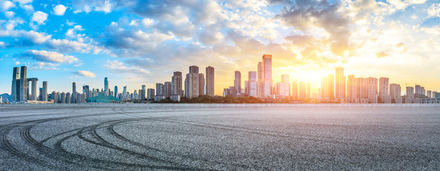 Fototapeta premium Empty asphalt road and Chongqing cityscape at sunset