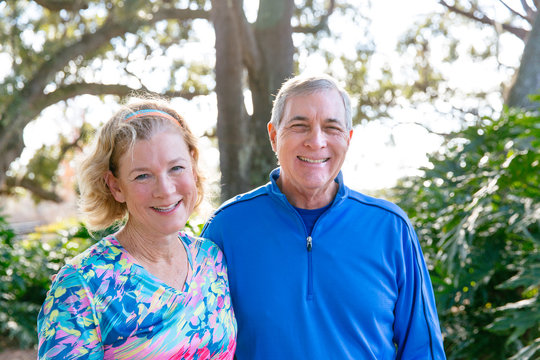 Portrait of an active mature couple in their sixties while outside for a walk.