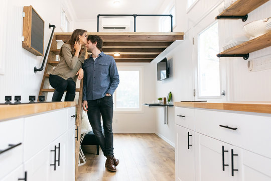 Home: Couple Share A Kiss On Loft Ladder