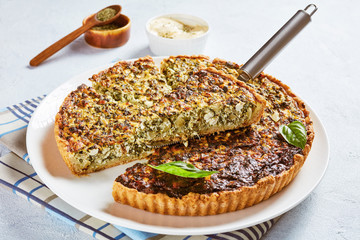 close-up of delicious sliced quiche with greens