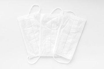 Flu prevention concept. Medical face mask on white background top view