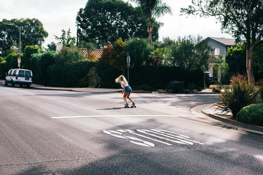 Young Anonymous Blonde Skateboarding in Quiet Venice California Street