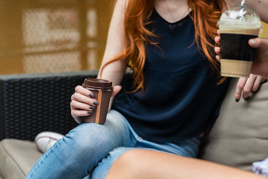 two women in a cafe with drinks