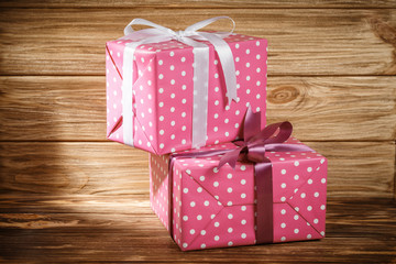 Gift box with ribbon on wooden background top view. 
