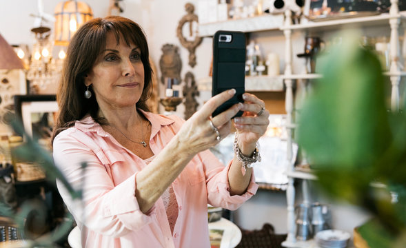 Shop: Woman Takes Photo Of Collectible Item