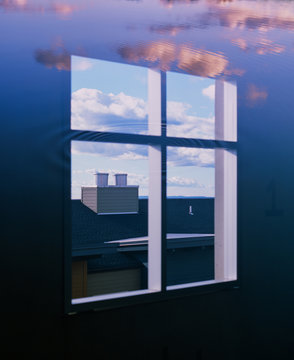 Window surrounded by water and clouds