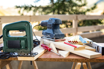 Fototapeta na wymiar Professional woodworking tools, manual electric saw for cutting wood. Housework do it yourself. Stock photography.