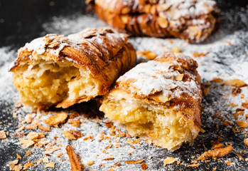 Croissants with almonds on the black background