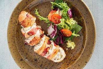 stuffed chicken wiht bacon and salad