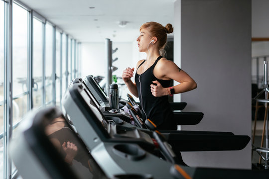 Young woman running in gym