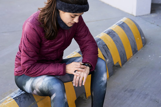Female runner with smartband watch.