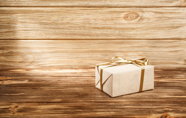 Gift box with ribbon on wooden background top view. 