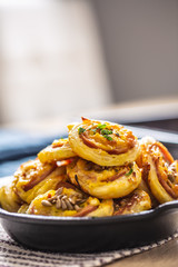 Rolls of puff pastry with ham bacon cheese sesame in dish
