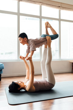 Mother and son practicing yoga at home