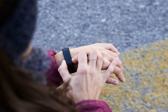 Female runner with smartband watch.