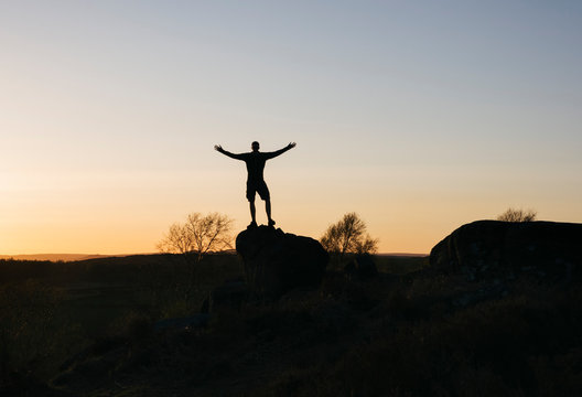 Male stood on Birchen Edge at sunset. Derbyshire, UK.