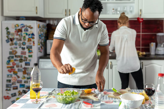 Couple cooking together in kitchen