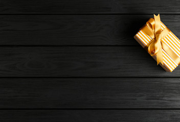 top view of a gift box on a black wooden background