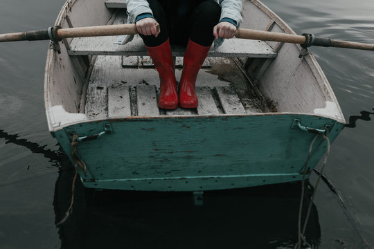 red rubber boots water puddle in row boat