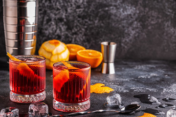 Negroni cocktail with orange peel and ice.